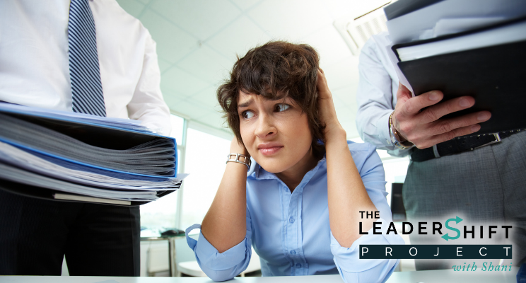 Overworked young office worker being given more work