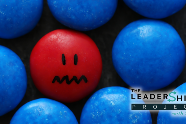 A red bead feels insecure and unsafe in a pool of blue beads.