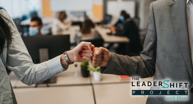 Alignment Article header Two coworkers, female and male, fist bump in agreement