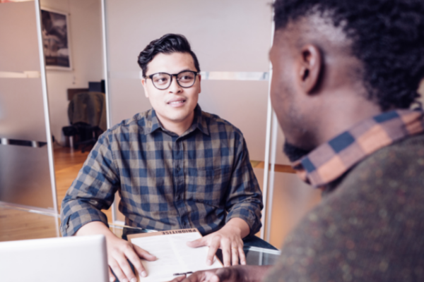 Male leader and employee having a one-on-one conversation in an office