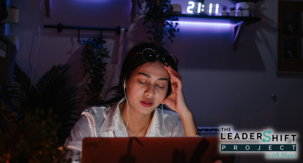 Female worker looking tired in front of a computer screen late at night