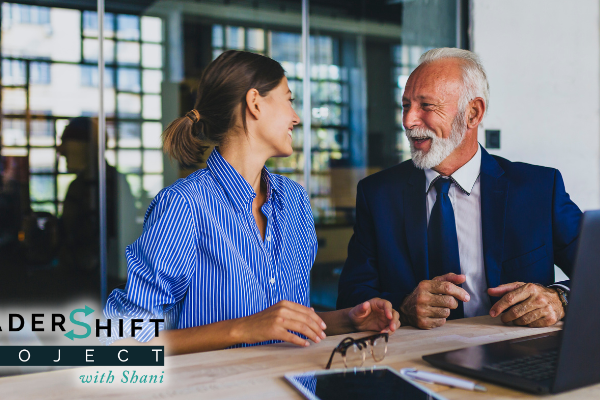 A manager and direct report have a one-on-one conversation in the workplace.